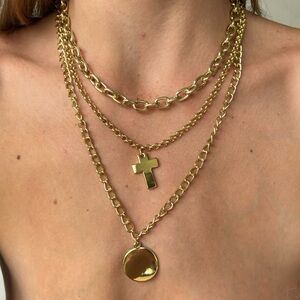 Gold plated triple chain necklace with a cross and circle pendant